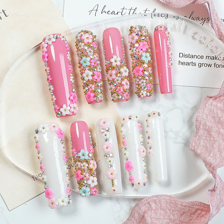 Artificial nail set with floral decorations and glitter accents Bowlift