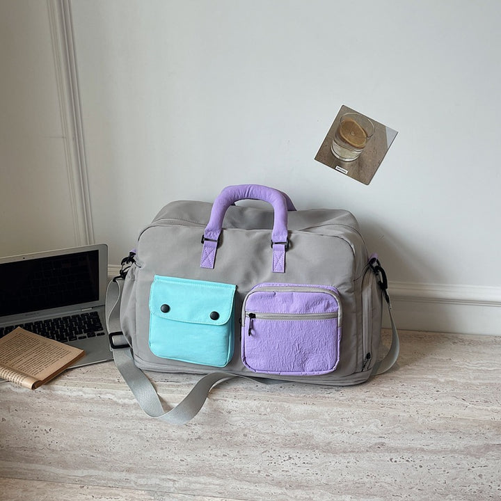 Sporty travel bag with multifunctional outer pockets Bowlift