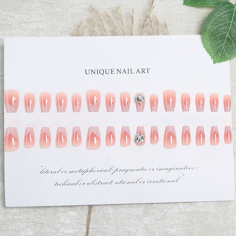 Artificial nail set with filigree tip designs and glamorous rhinestone accents Bowlift