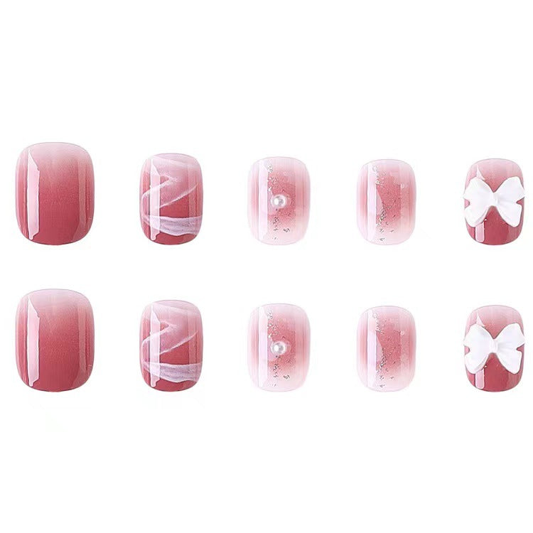 Glamorous nail art with pearl and bow accents Bowlift