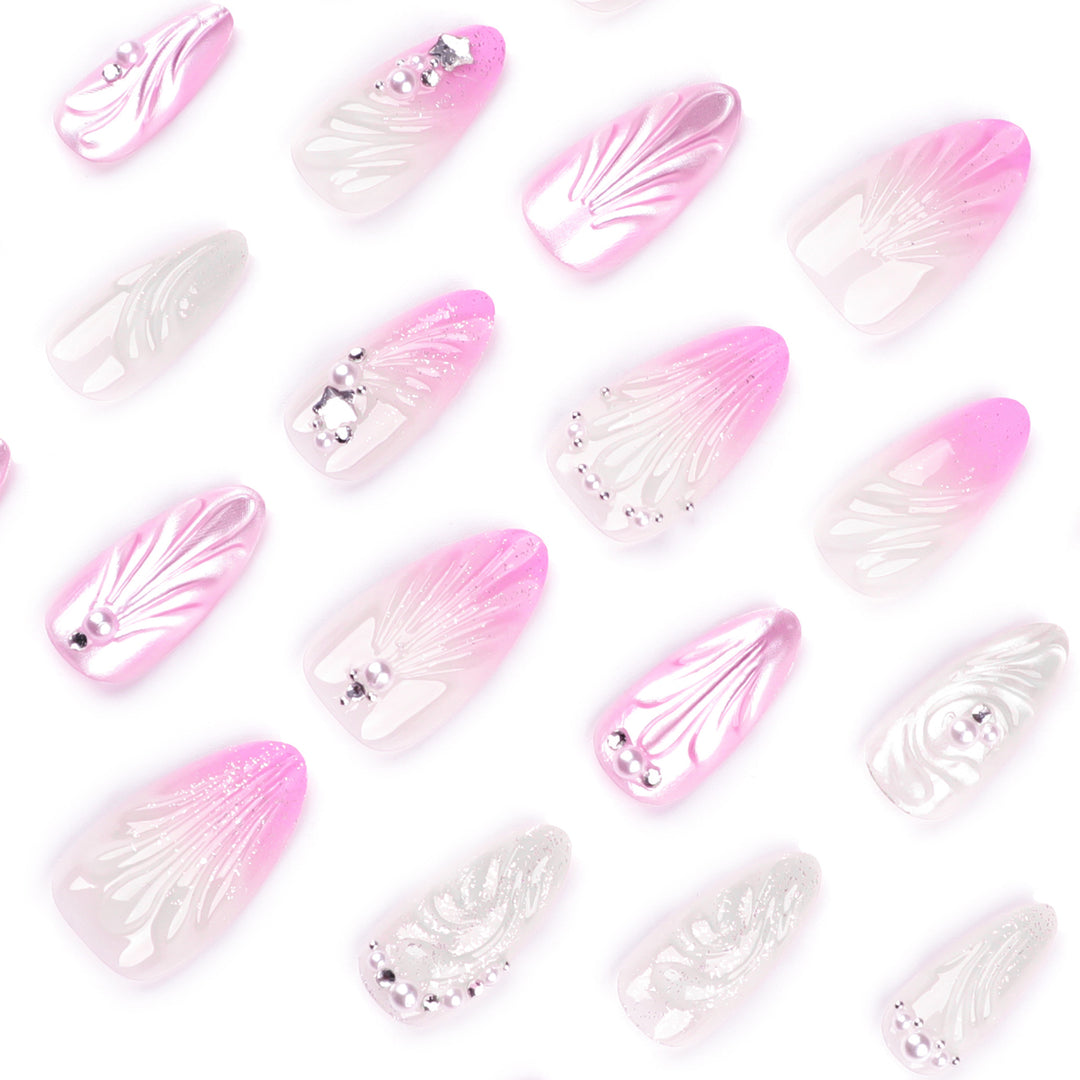 Artificial nail art with elegant swirl design and pearl embellishments Bowlift