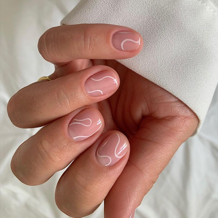 Elegant Press-On Nail Design with Artistic White Swirl Bowlift