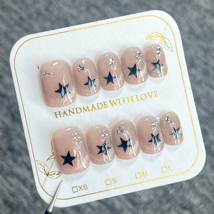 Artistic acrylic nails with glamorous star motifs Bowlift