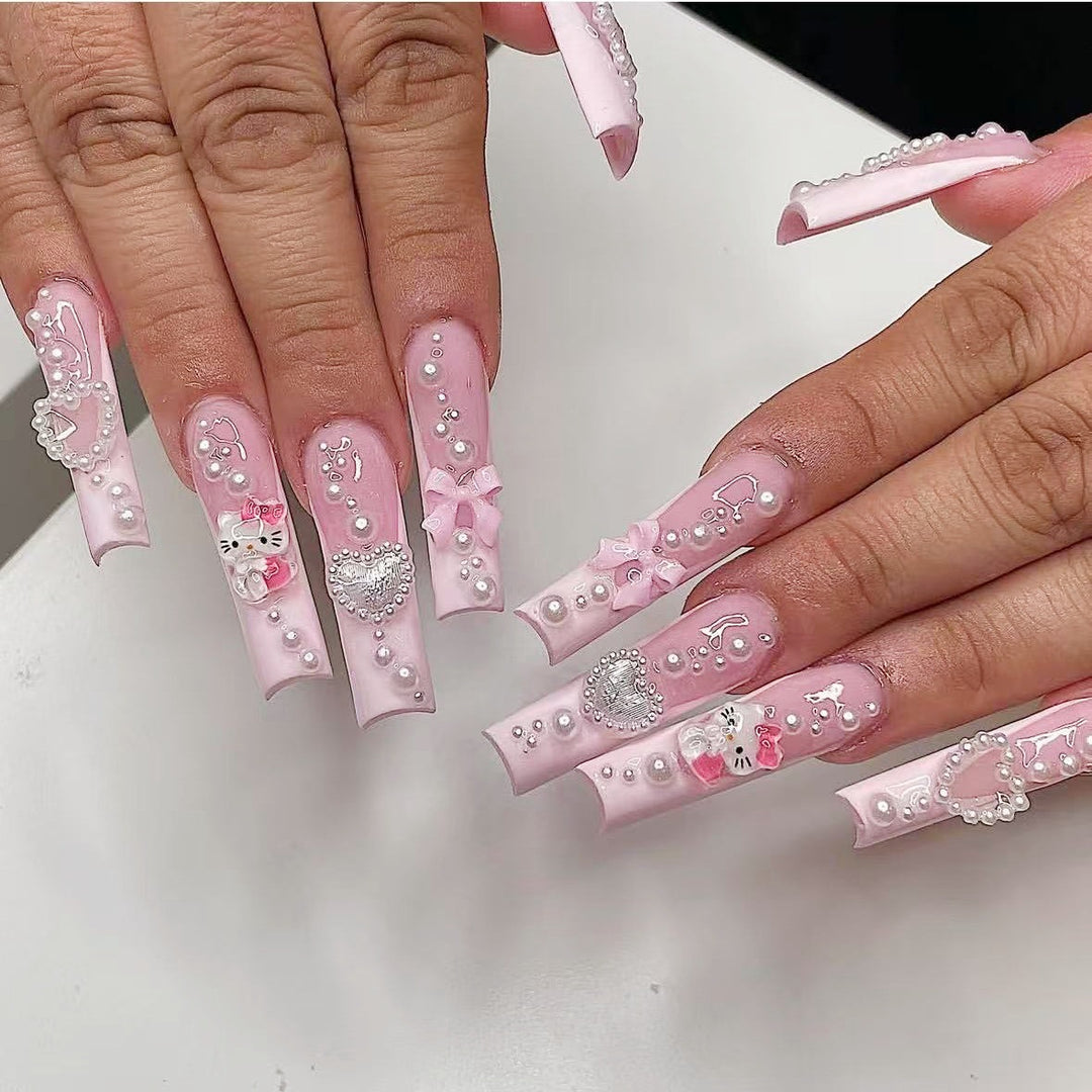 Artificial nail set with playful 3D care and pearl decorations Bowlift