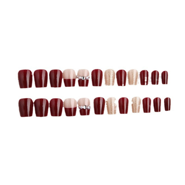 Glamorous artificial nails with glitter and pearl decorations Bowlift