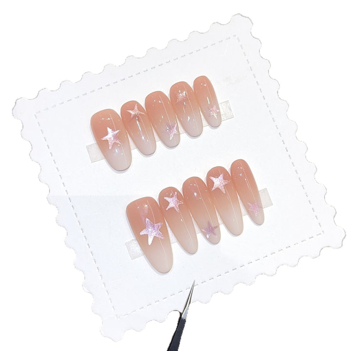 Artificial nails with sparkling stars and gentle gradient Bowlift