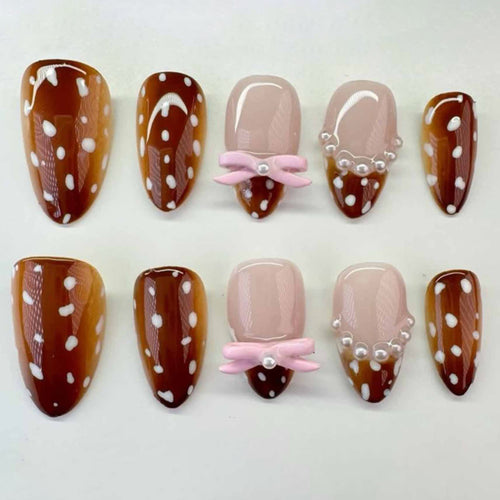 Artificial nail art with dot pattern and bow accents Bowlift
