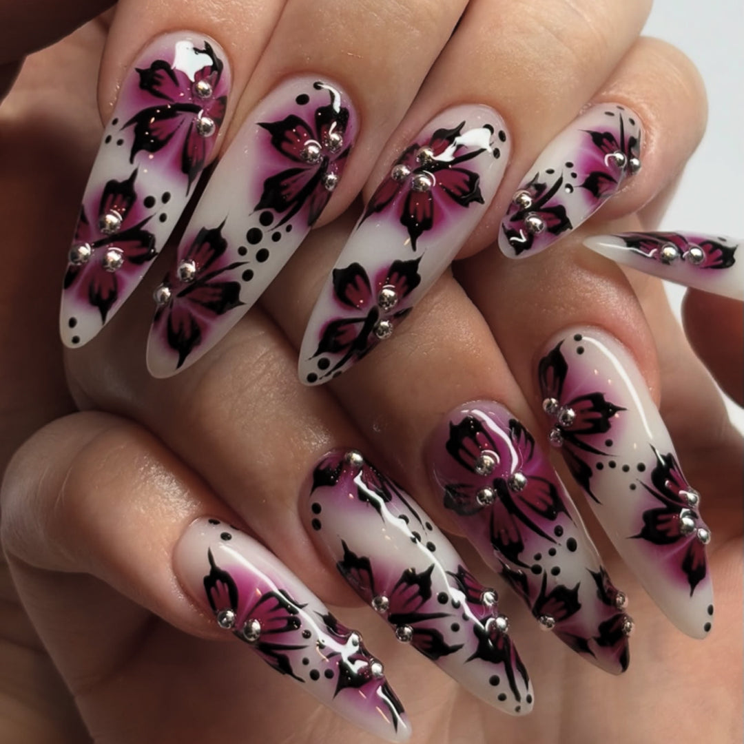 Artful nail art with floral design and rhinestone accents Bowlift