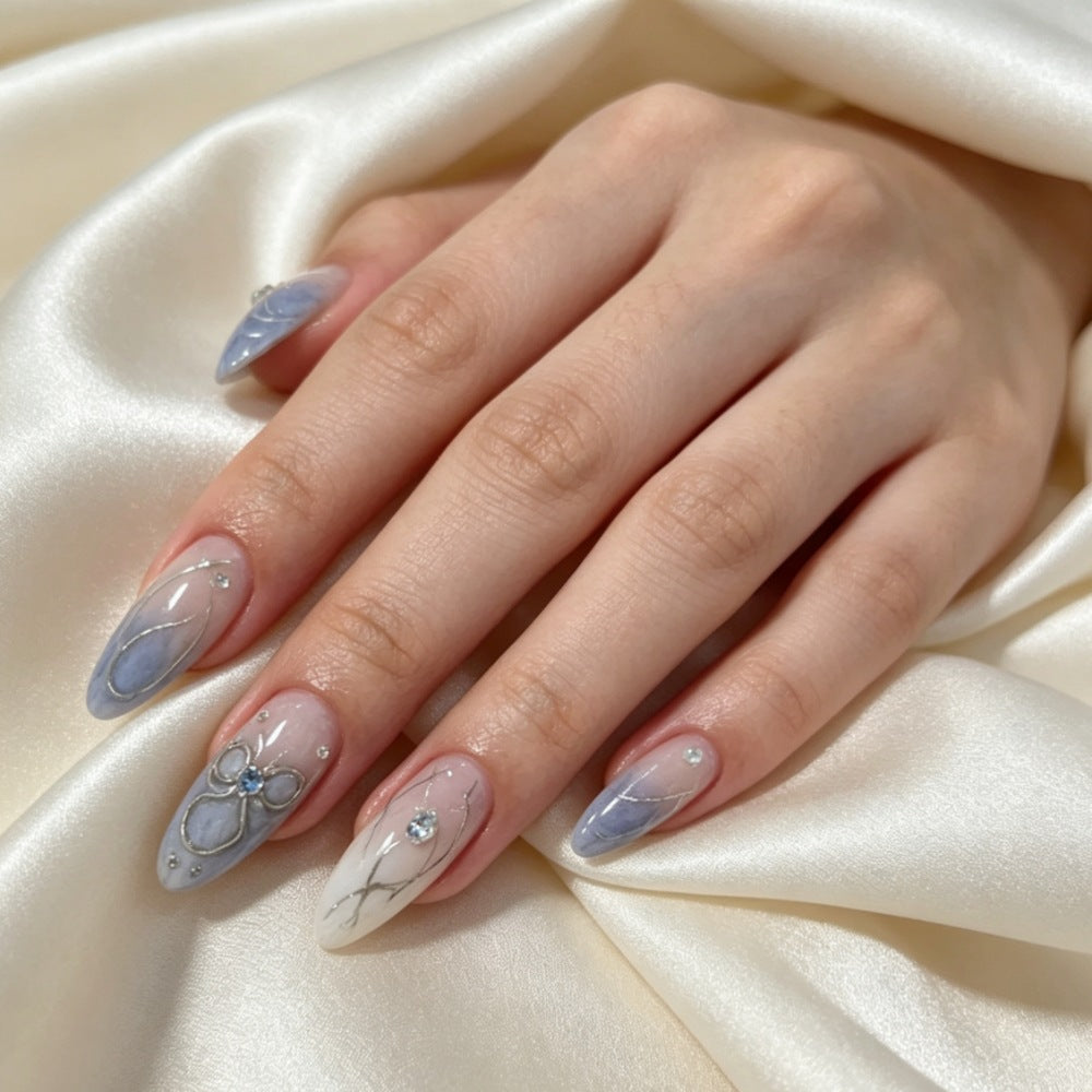 Artistic Press-On Nail Design with Floral and Gem Accents Bowlift
