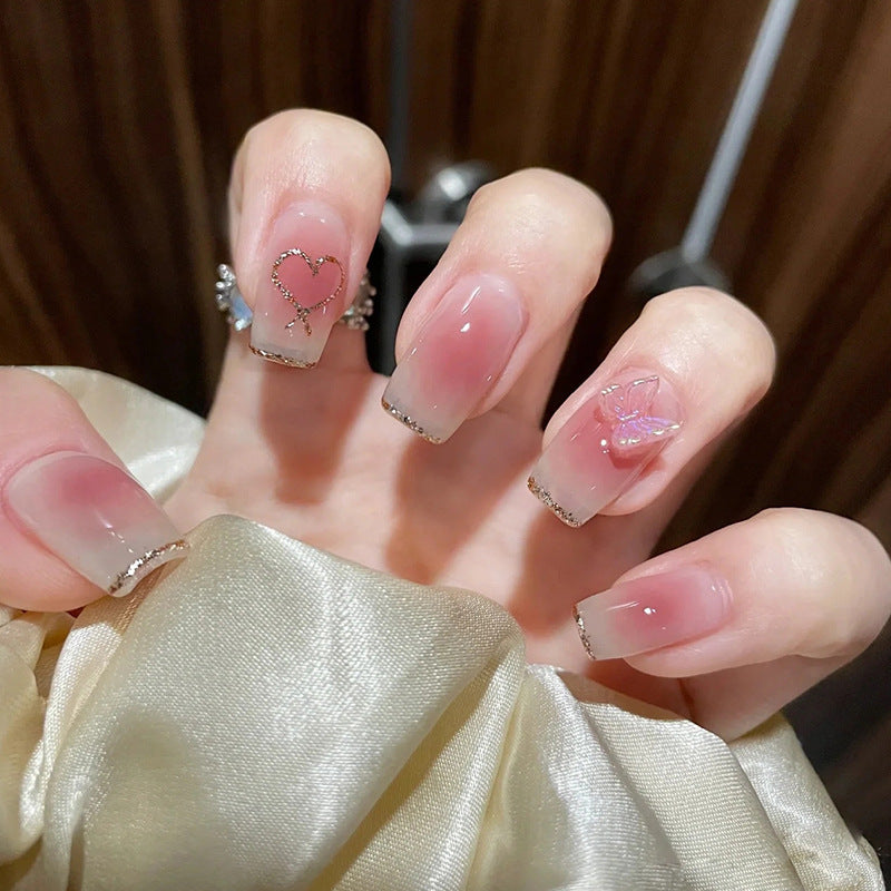 Artificial nails with heart design and glamorous accents Bowlift