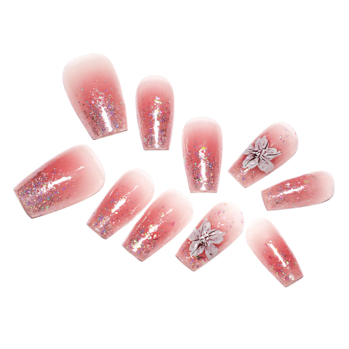 Artificial nail extensions with floral design and glitter accents Bowlift