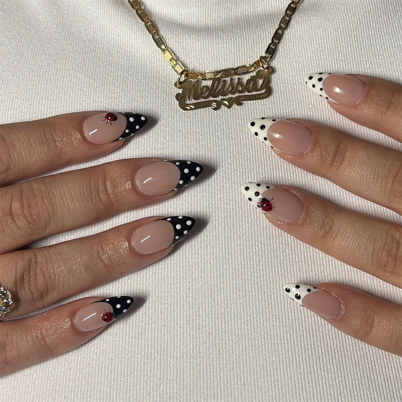 Acrylic nail set with polka-dotted accents and sparkling details Bowlift