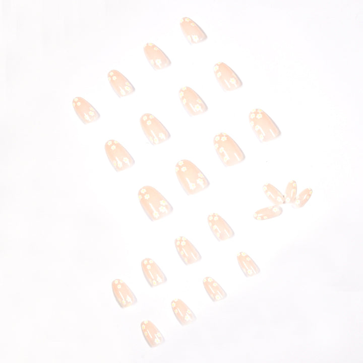 Artificial nail art with floral design and glitter accents Bowlift