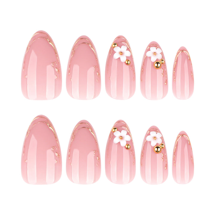 Artful nail design with golden accents and floral details Bowlift