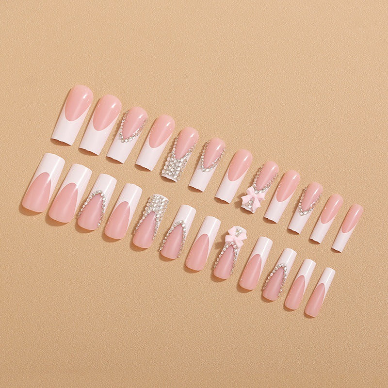 Artificial nails with glamorous rhinestone decorations and floral accents Bowlift