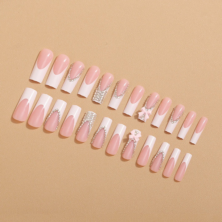 Artificial nails with glamorous rhinestone decorations and floral accents Bowlift