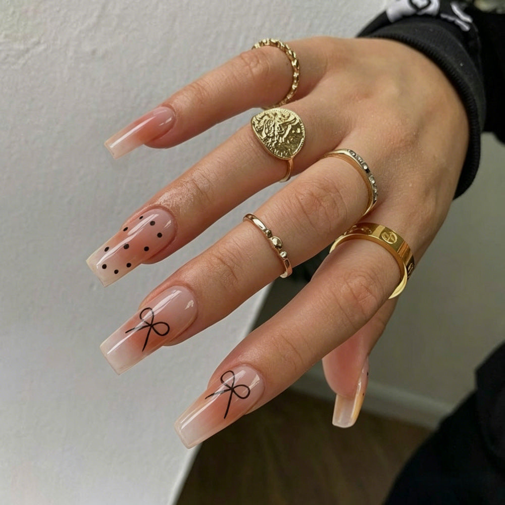 Artificial nails in luxurious French tip design with bow accents Bowlift