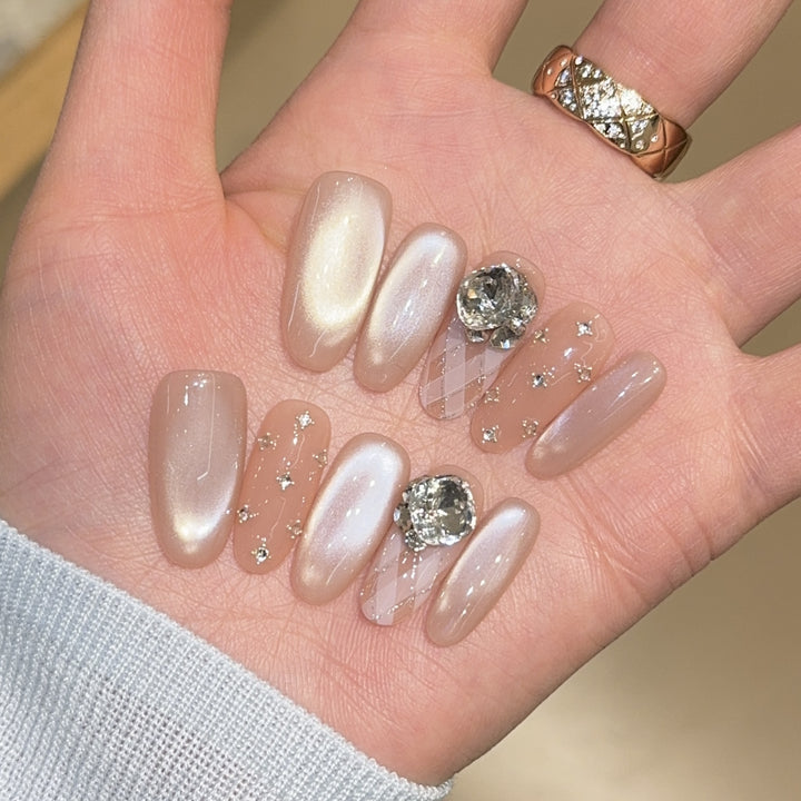 Elegant artificial nails with shimmering effects and rhinestone accents Bowlift
