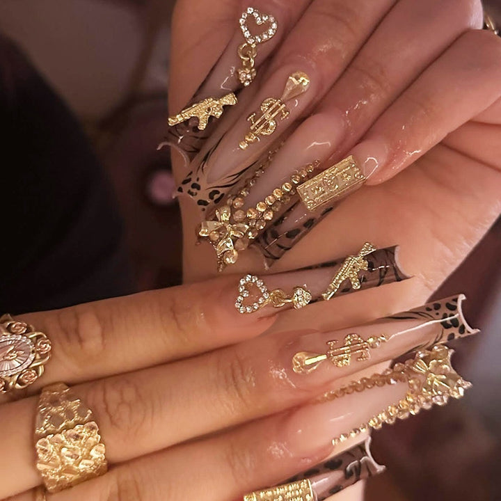 Glamorous artificial nail set with sparkling rhinestones and cross decorations Bowlift