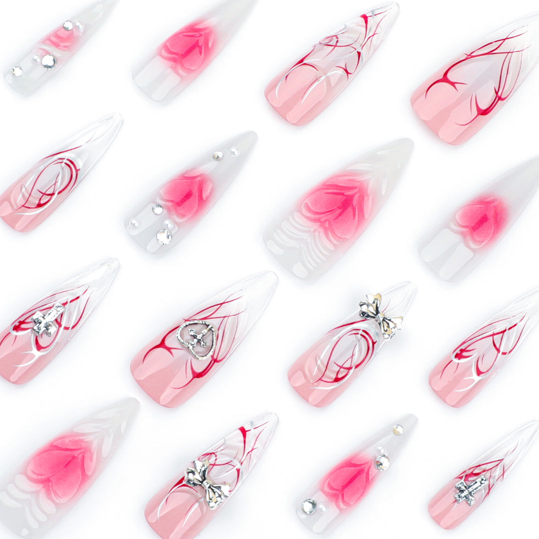 Artful stiletto nails with elegant floral accents and glitter embellishments Bowlift