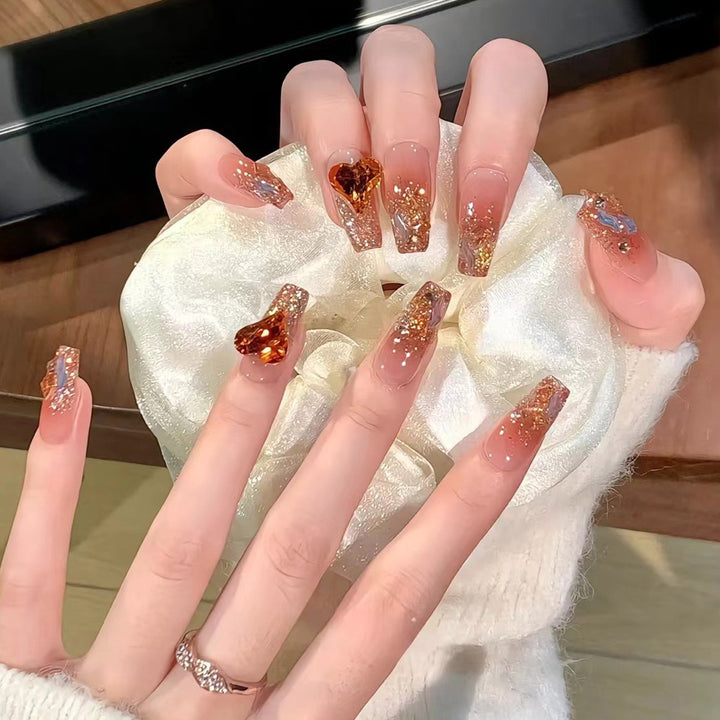 Artistic acrylic nails with heart design and sparkling accents Bowlift