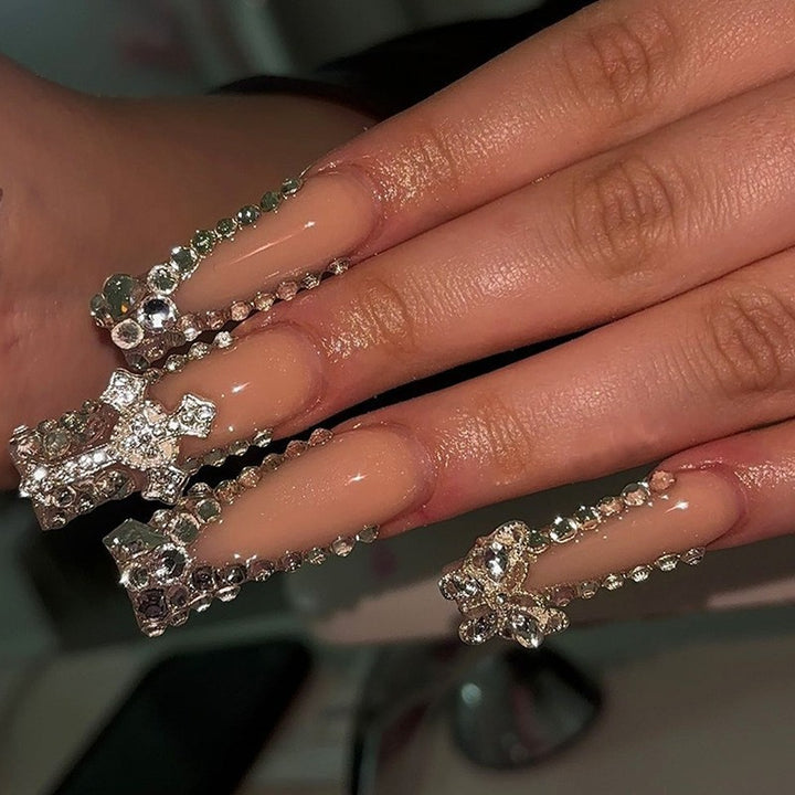 Glamorous artificial nail set with sparkling rhinestones and cross decorations Bowlift