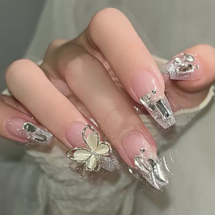 Glamorous artificial nails with heart design and glittering accents Bowlift