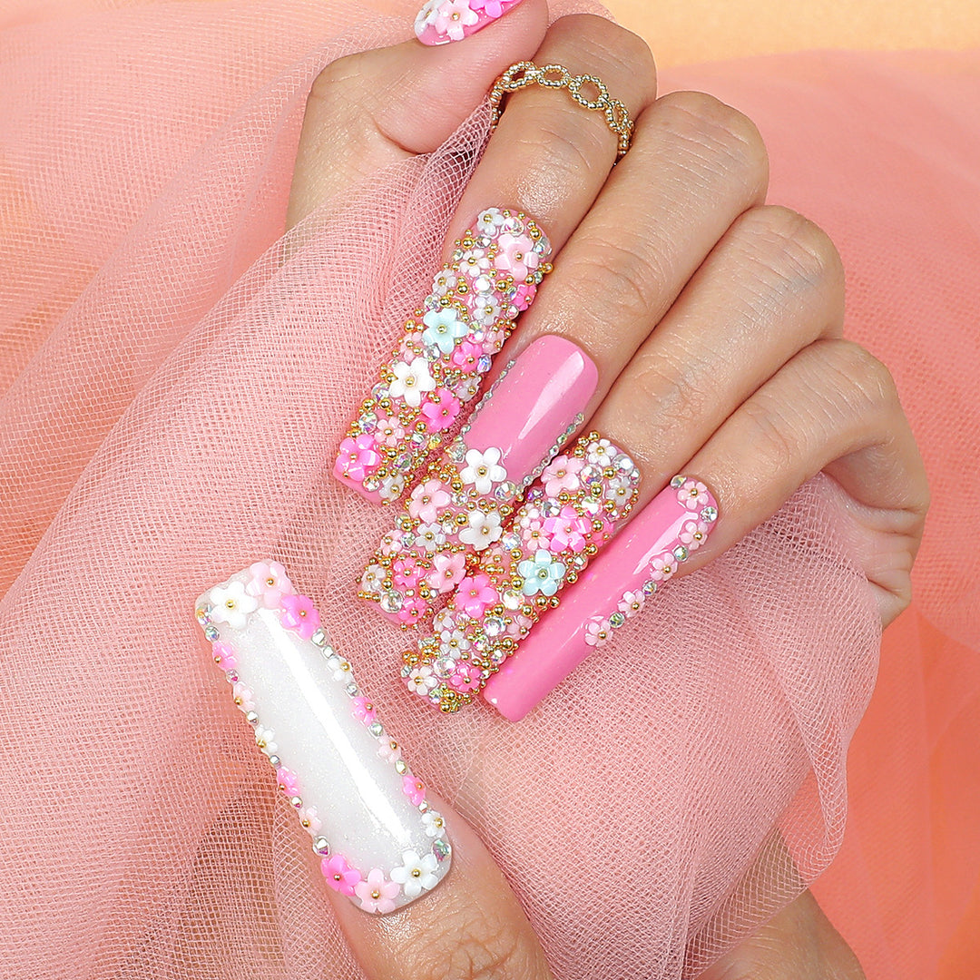 Artificial nail set with floral decorations and glitter accents Bowlift