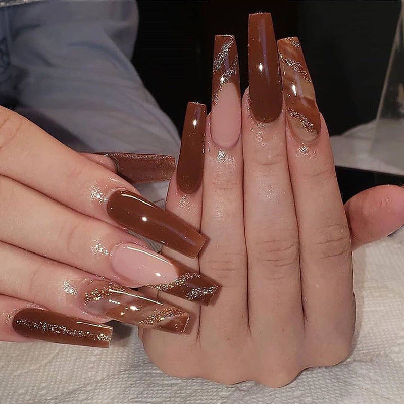 Artful gel nails in elegant high-gloss design with glitter accents and stylish patterns Bowlift