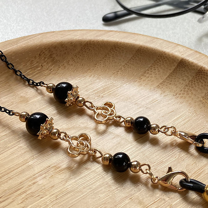 Filigree glasses chain holder with pearls and golden accents Bowlift