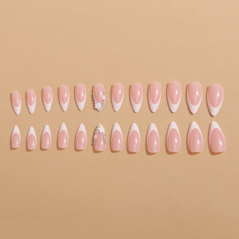 Artificial nails with elegant French tips and rhinestone details Bowlift