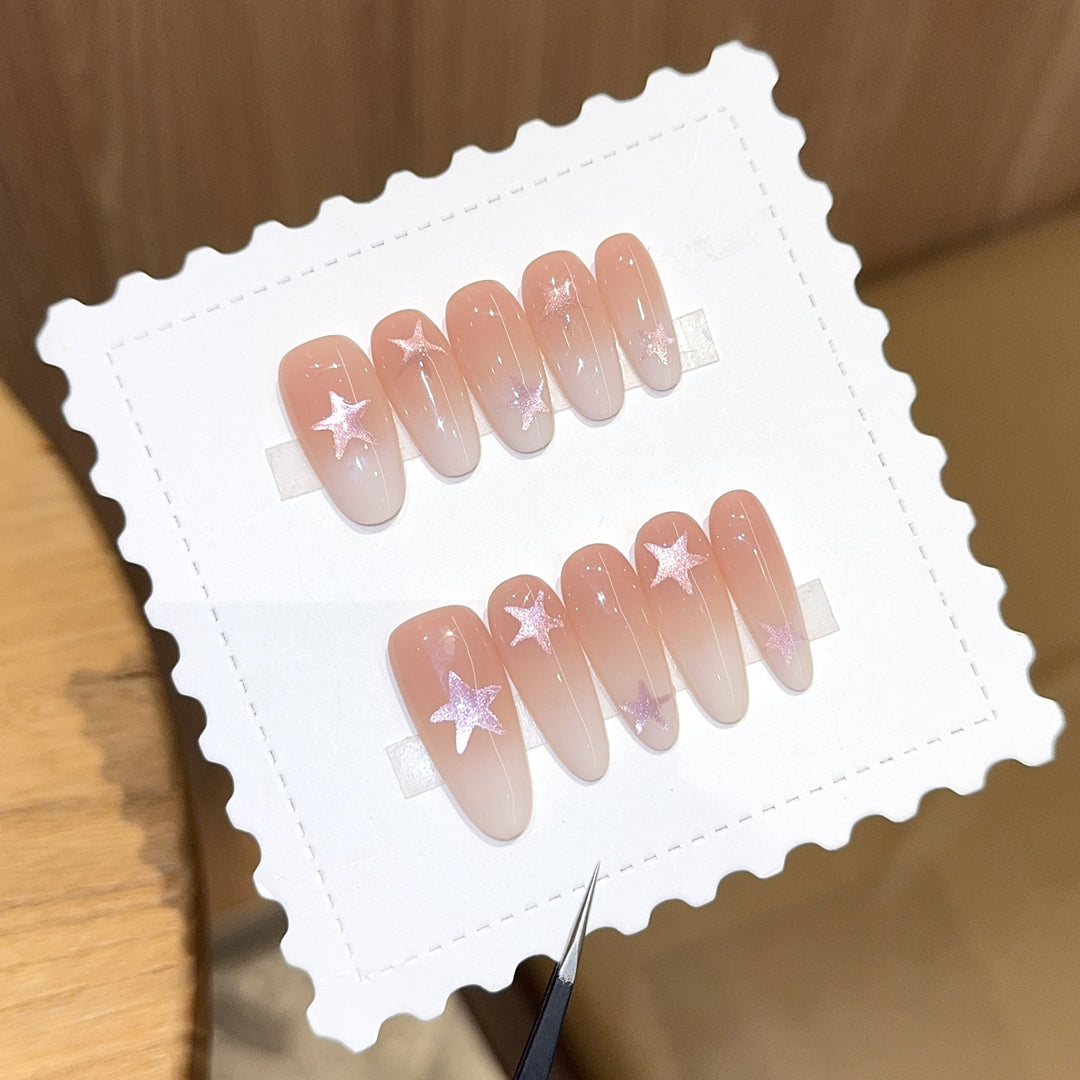 Artificial nails with sparkling stars and gentle gradient Bowlift