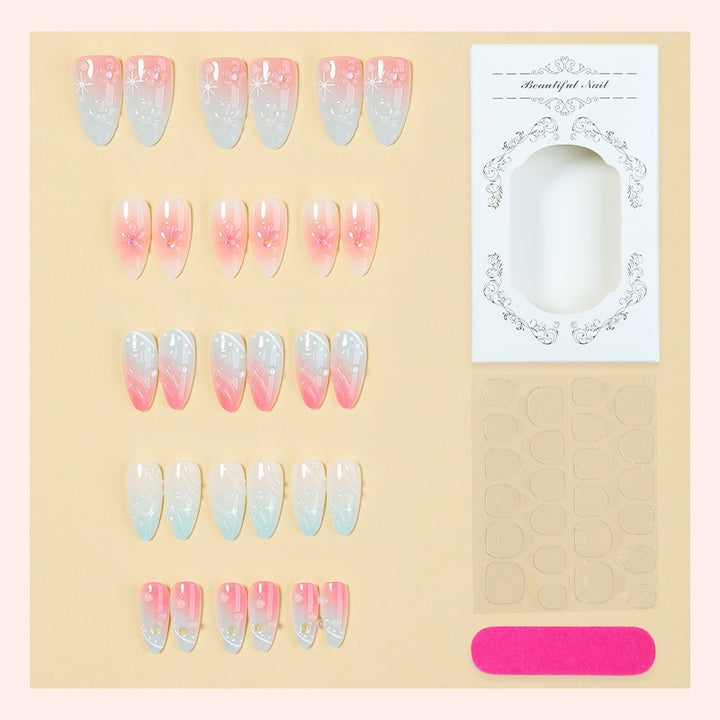 Acrylic nail set with elegant ombre design and floral decorations Bowlift