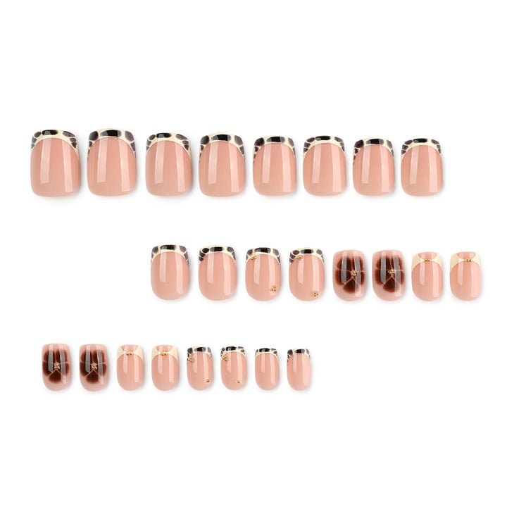 Artful nail extensions with an elegant giraffe pattern and golden accents Bowlift