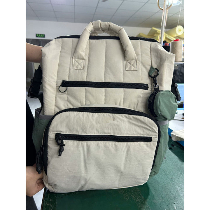 Multifunctional backpack with padded carrying handles and multiple compartments Bowlift