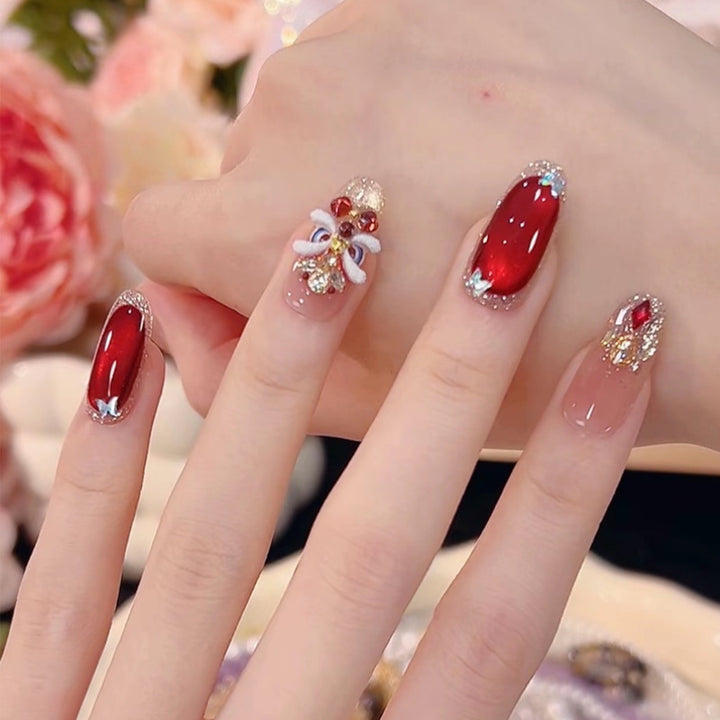 Artificial nail set with festive gift design and elegant glitter accents Bowlift
