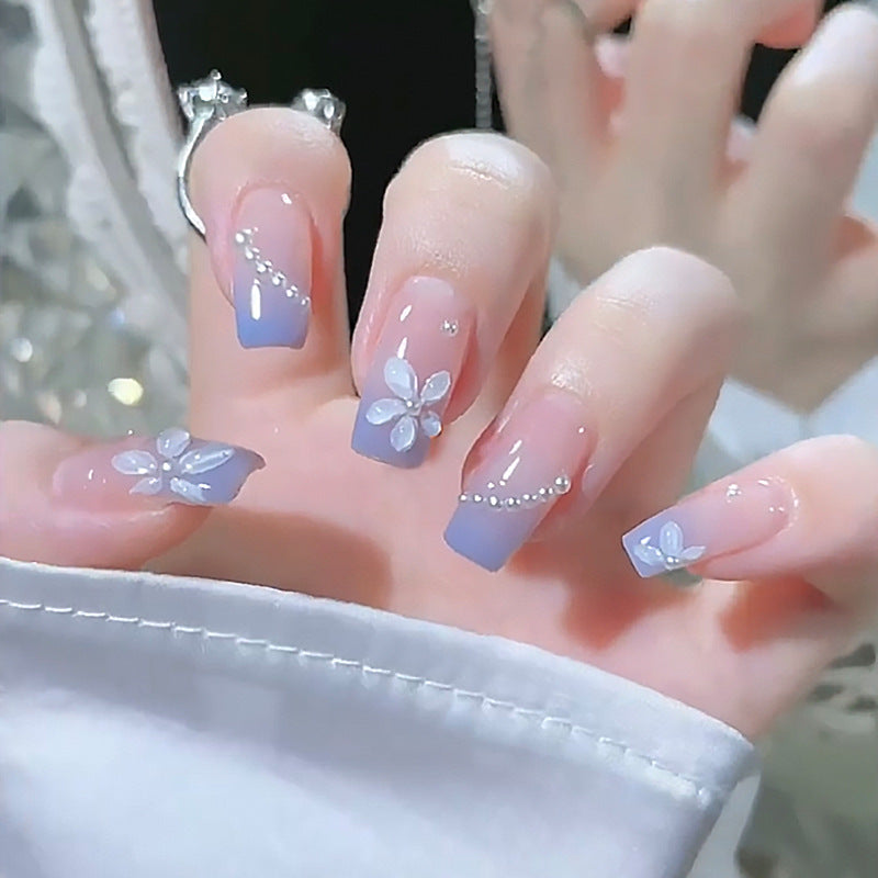 Nail set with elegant floral accents and glitter embellishments Bowlift