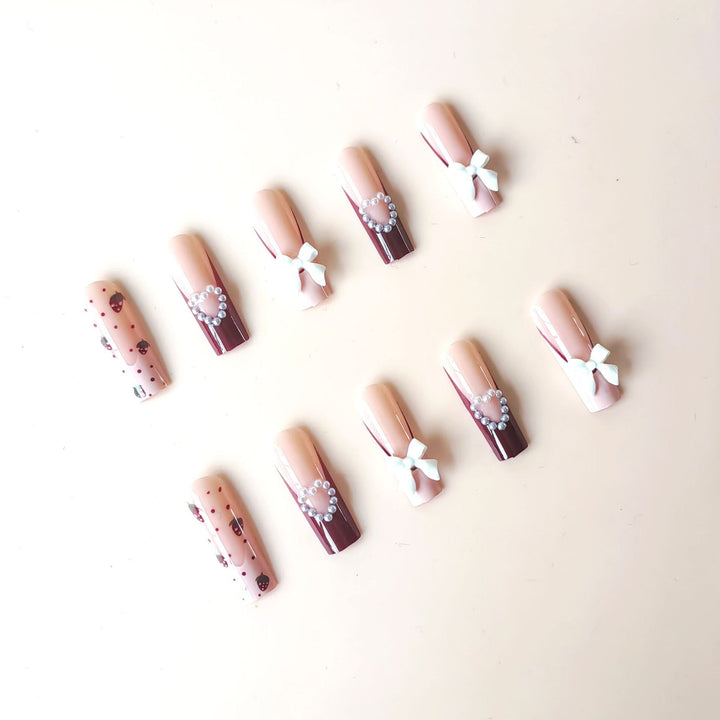 Artificial artificial nails with heart designs and holographic accents Bowlift