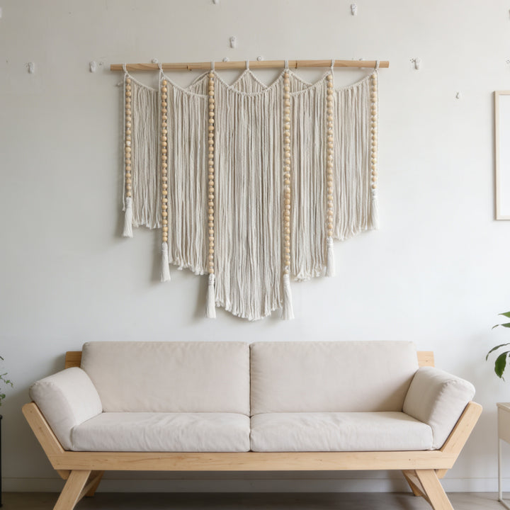 Macramé wall hanging with intricate fringes and wooden beads