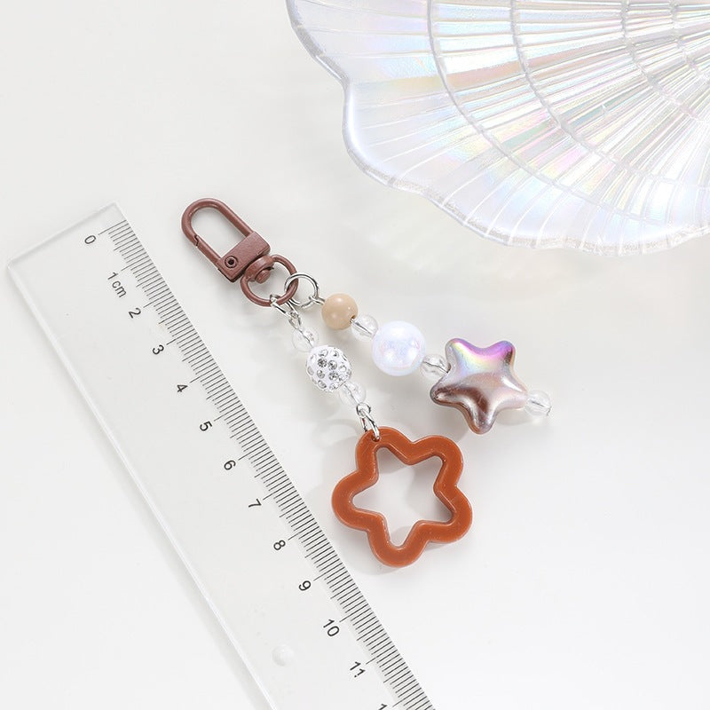 Playful keychain with floral and star motif Bowlift