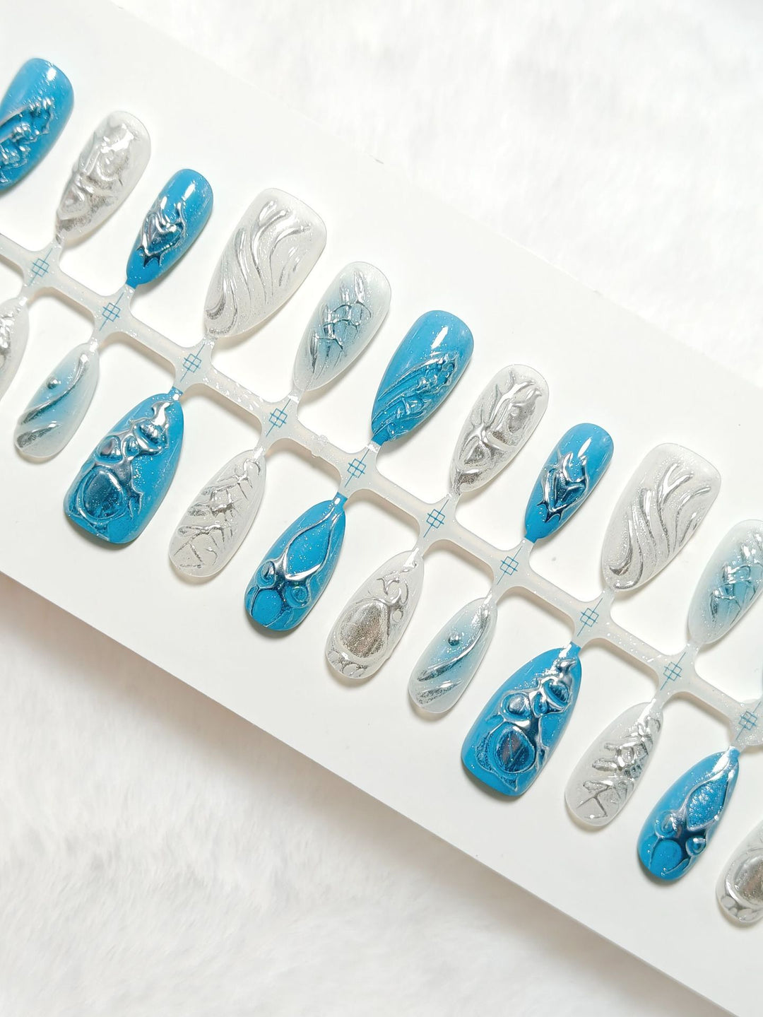 Creative artificial nails with shiny silver and turquoise tones Bowlift