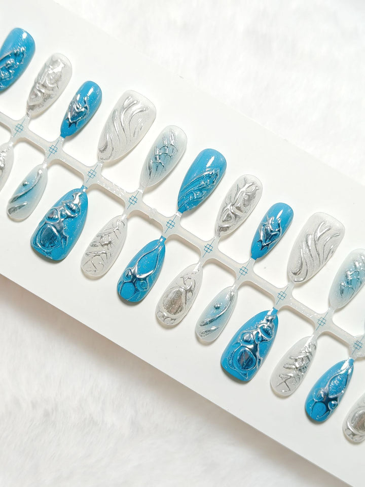 Creative artificial nails with shiny silver and turquoise tones Bowlift