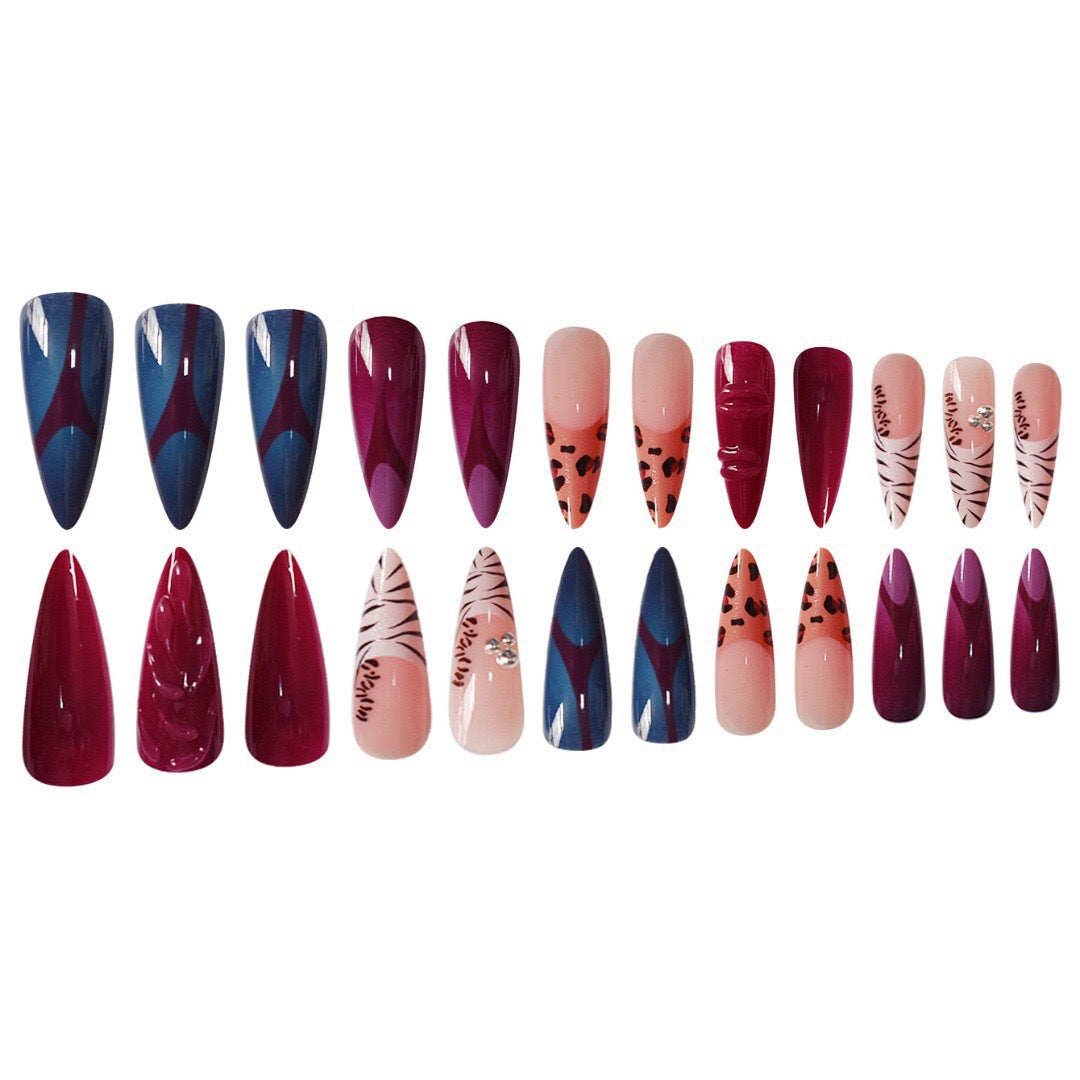 Artistic Stiletto Nail Enhancements with Trendy Animal Print and Gem Accents Bowlift