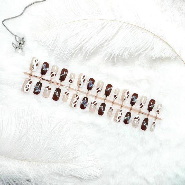 Artificial nails with sparkling rhinestone and bow accents Bowlift