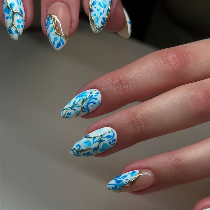 Artistic Floral Press-On Nail Design with Gold Accents Bowlift