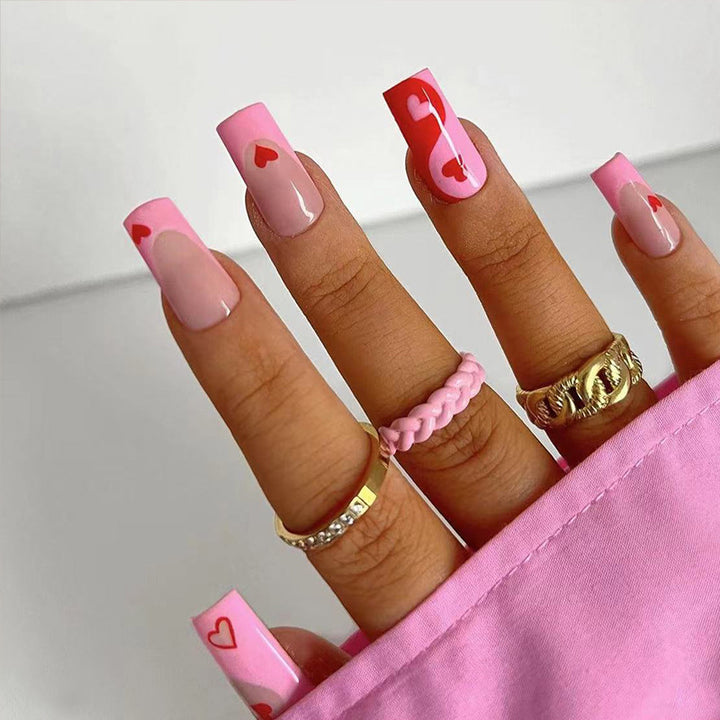 Artificial nail art with heart design and glitter accents Bowlift