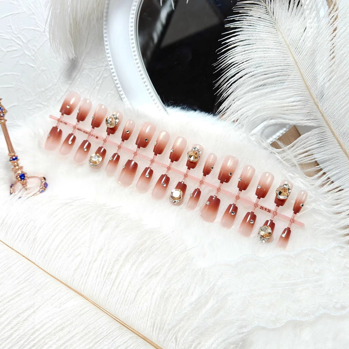Artificials nails in elegant ombre style with rhinestone embellished applications Bowlift
