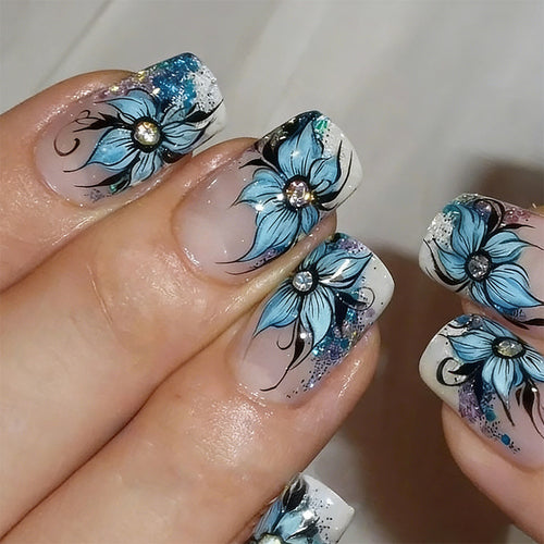 Artificial nail set with intricate floral designs and glitter elements Bowlift