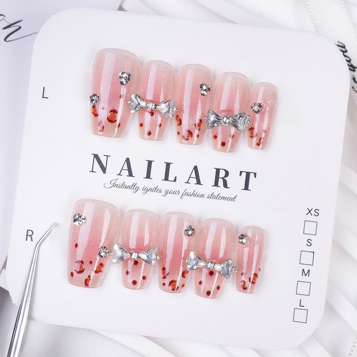Art nails with delicate rhinestone and bow accents Bowlift
