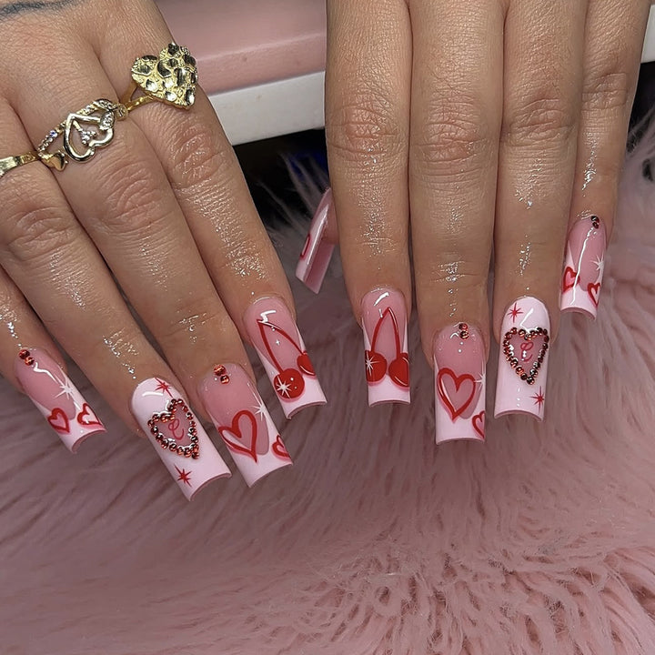 Artificial nail set with romantic heart designs and sparkling rhinestone decorations Bowlift